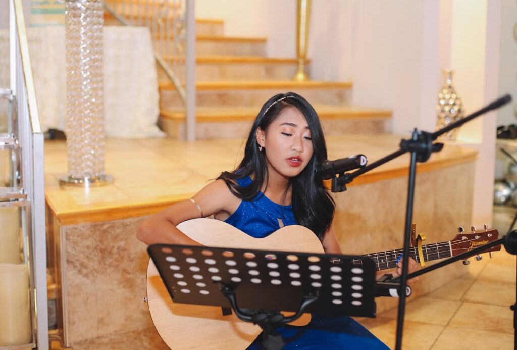 wedding image of a girl singing on a guitar